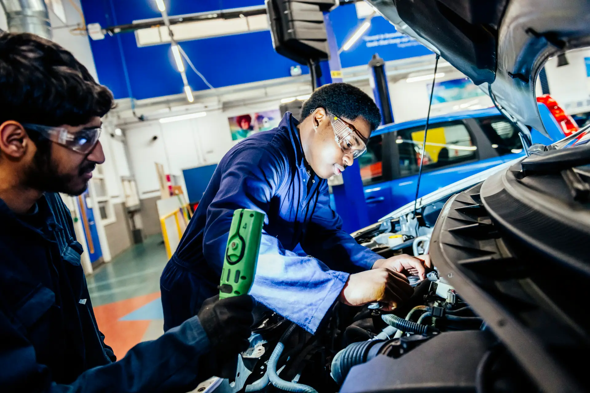 Students working under car bonnet