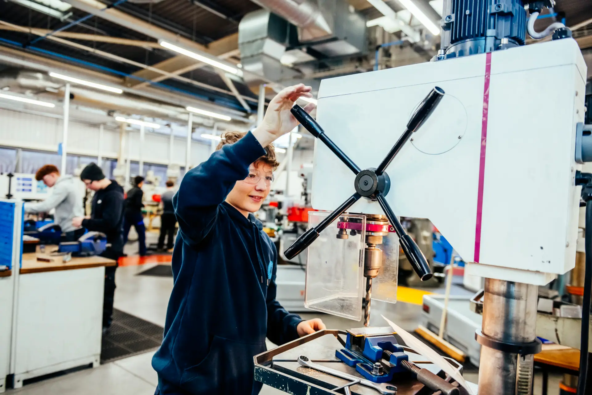 Engineering student using equipment in workshop