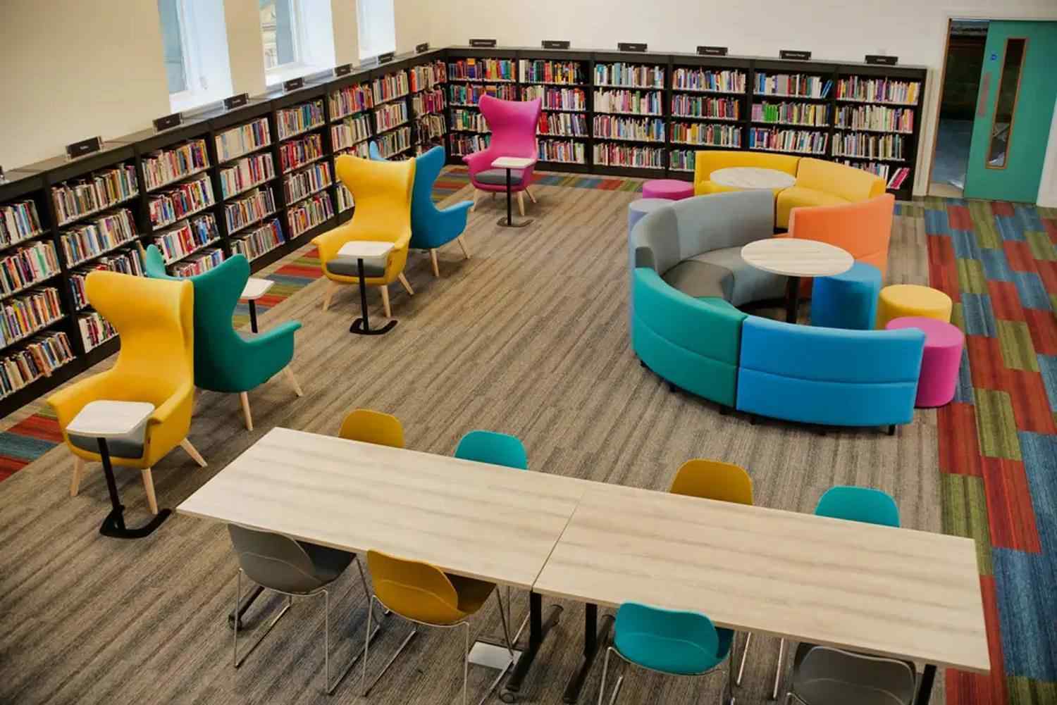 A vibrant college library with colourful seating, bookshelves, and a modern design, promoting a welcoming learning environment.