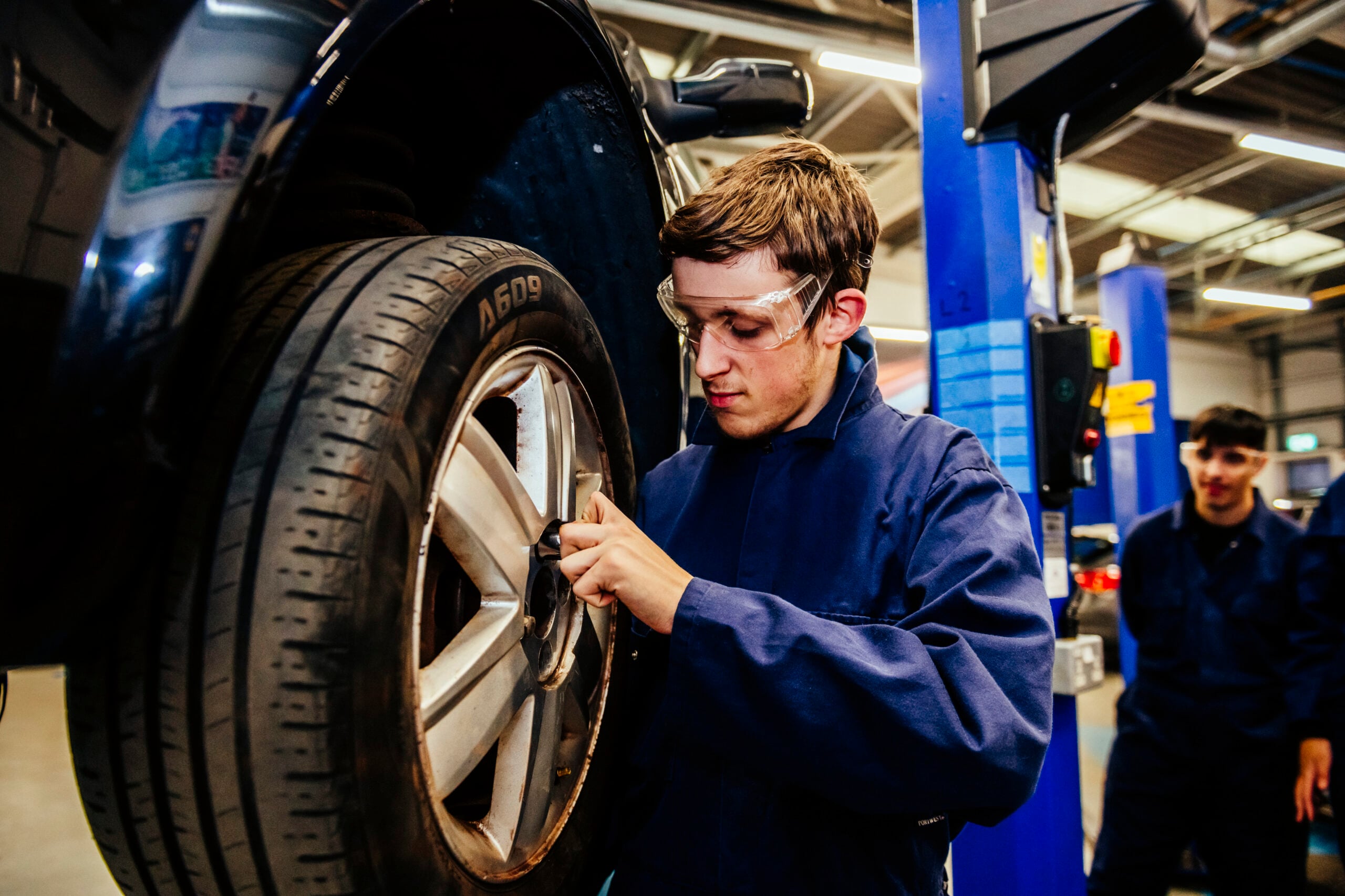 Student working with car tire