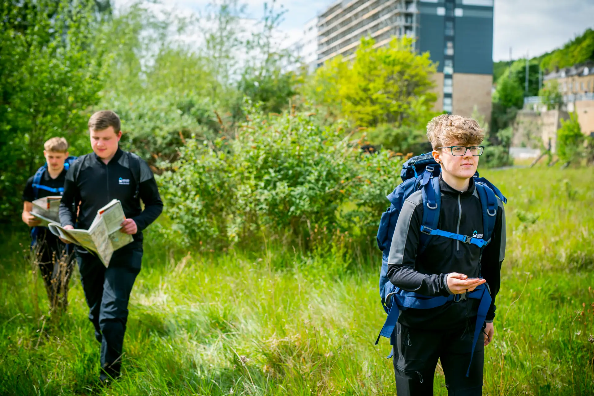 Students on a hike with one reading a map
