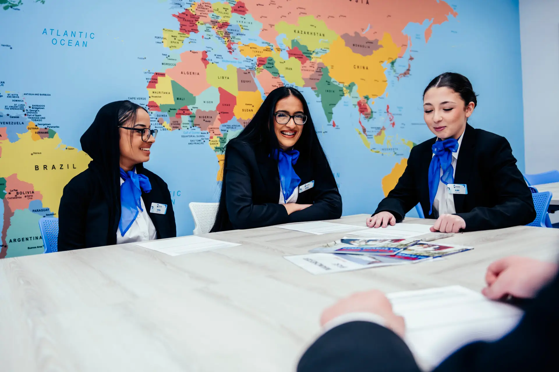 Students sat in front of a world map