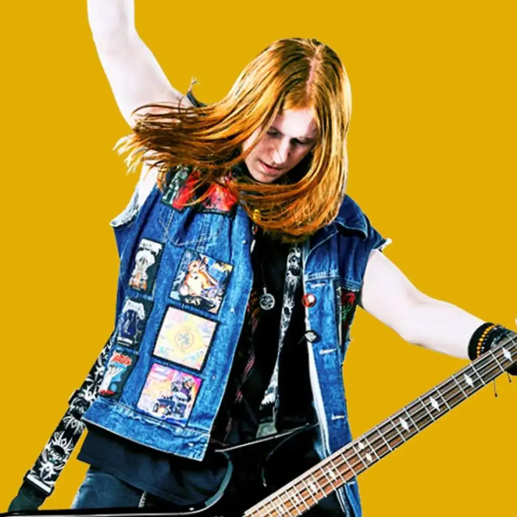 A person with long hair playing an electric guitar, wearing a denim vest with band patches, against a yellow background.