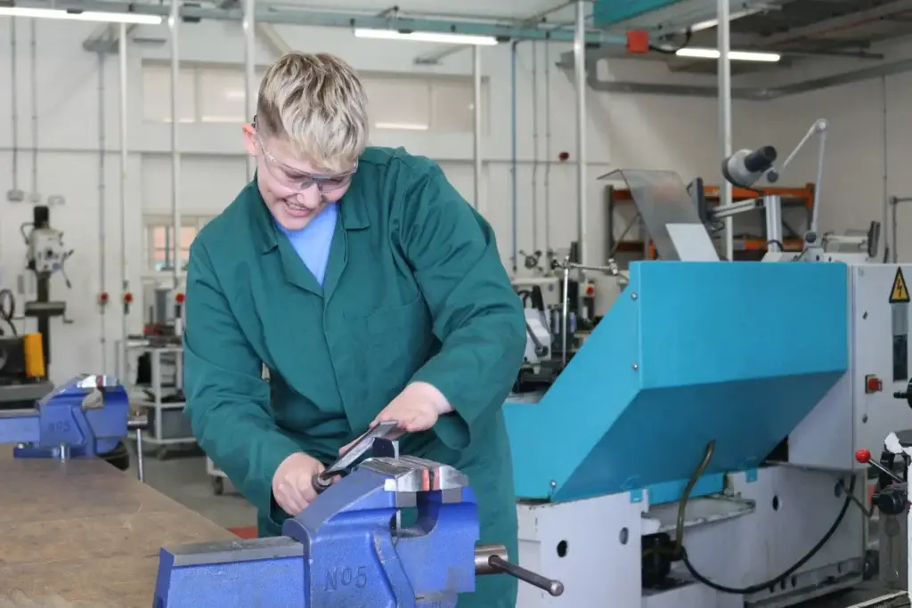 smiling girl doing work on machine