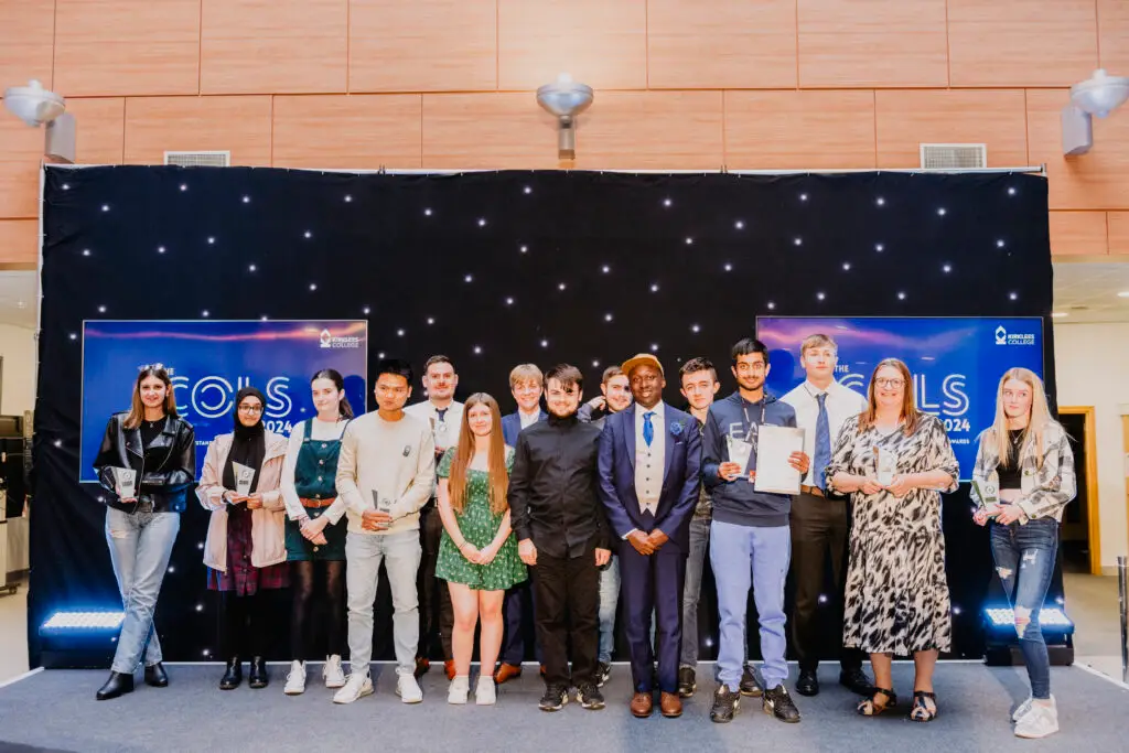 award winner stood together on stage with their awards