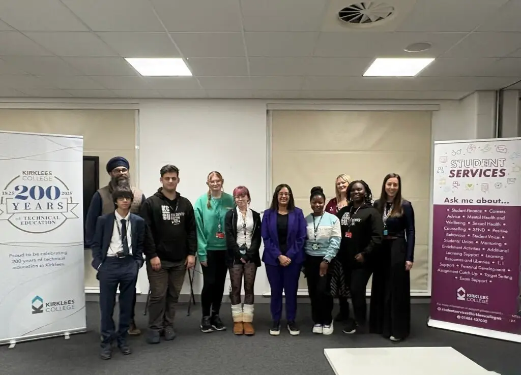 Kirklees College students stand in a line with Harpreet Uppal in the middle