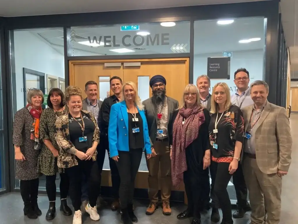 Senior Members of the Kirklees College team line up in front of the entrance to the new Innovation Hub