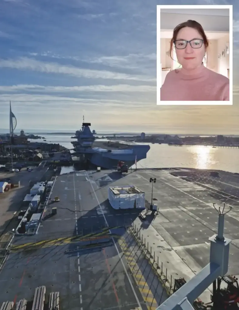 aircraft carrier in port with image of Samantha in the corner of the image