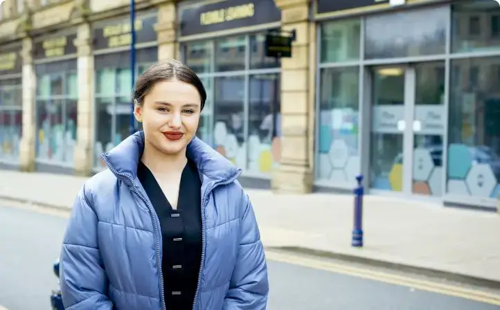 girl with blue jacket standing on road