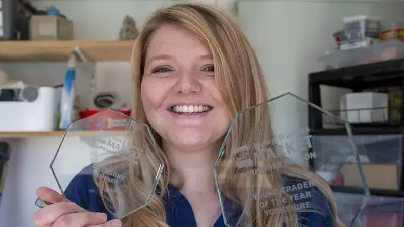girl showing her two awards