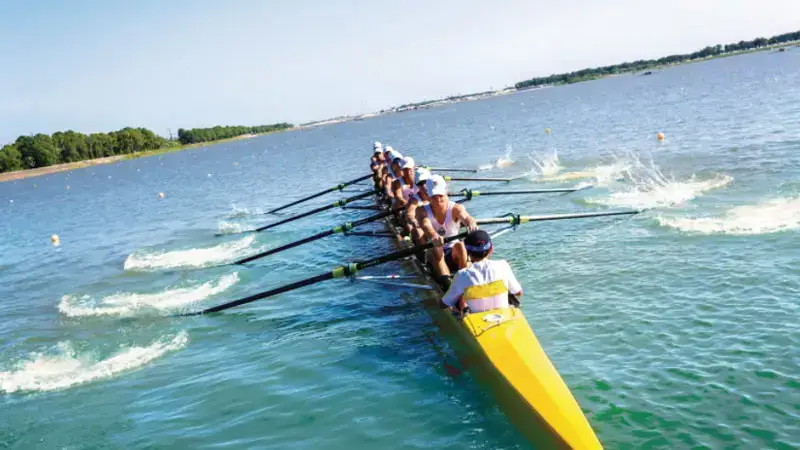 8 person rowing in open water