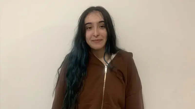 smiling girl with brown jacket