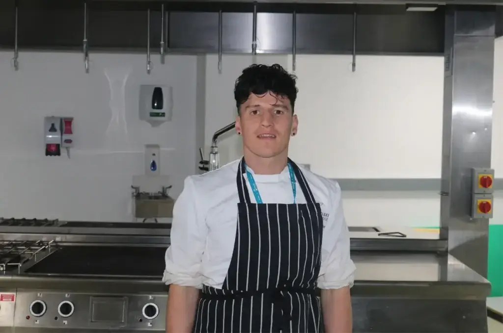 a boy with white and black kitchen wear