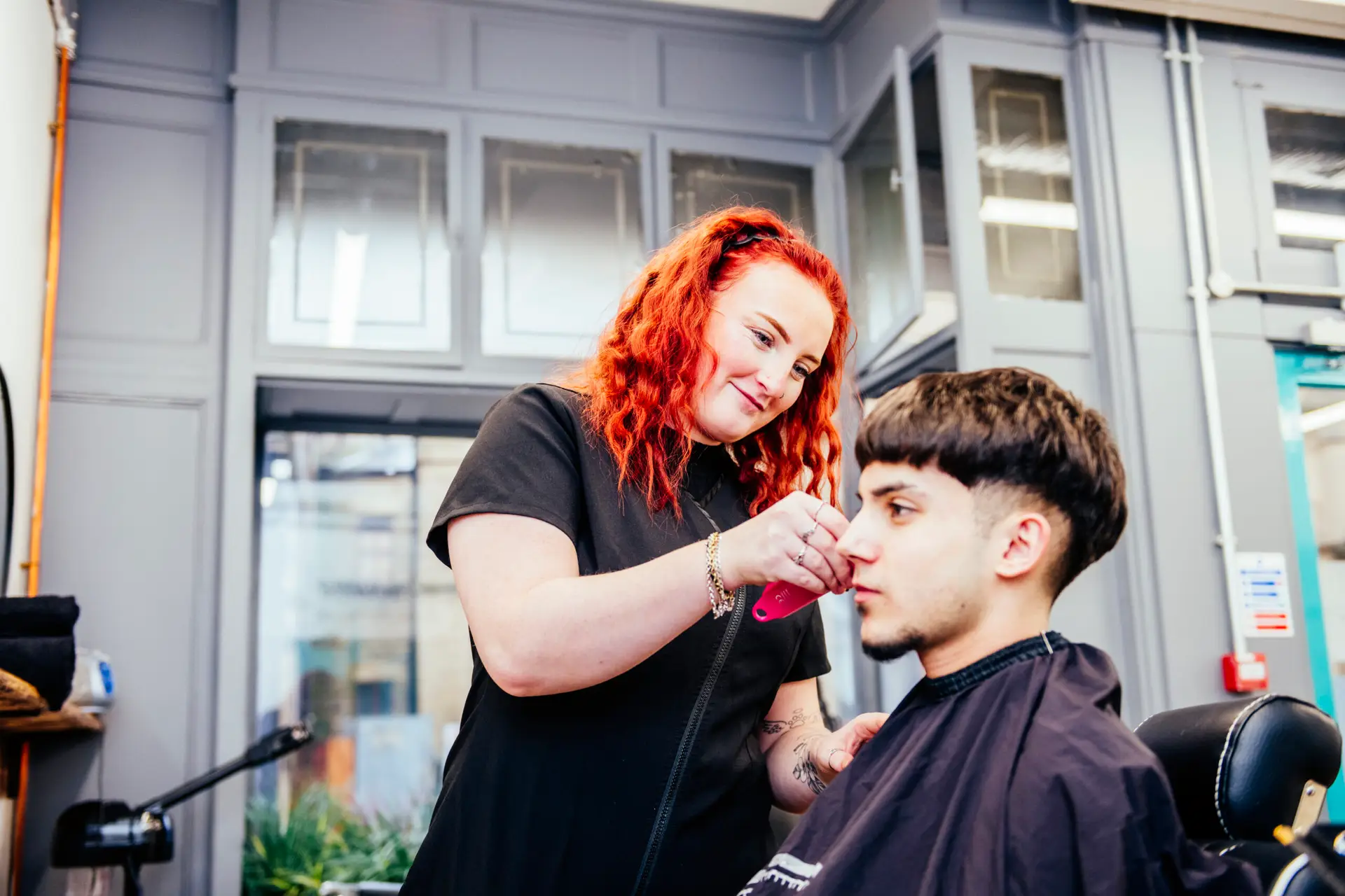 Barbering student with customer