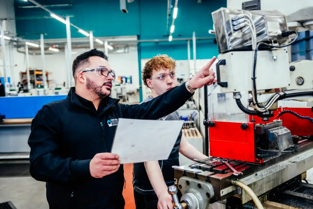 Engineering tutor points to equipment