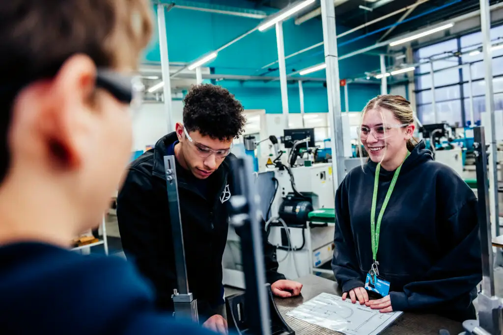 Student smiling whilst listening to tutor