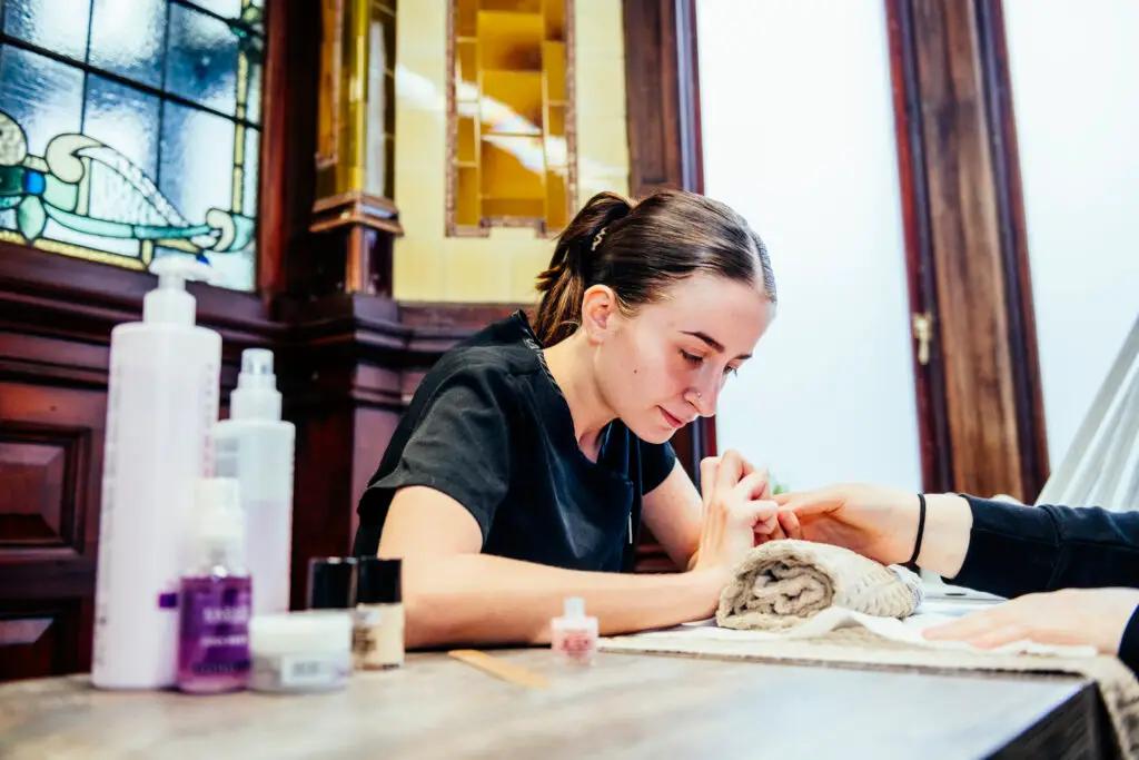Nail technician with customer