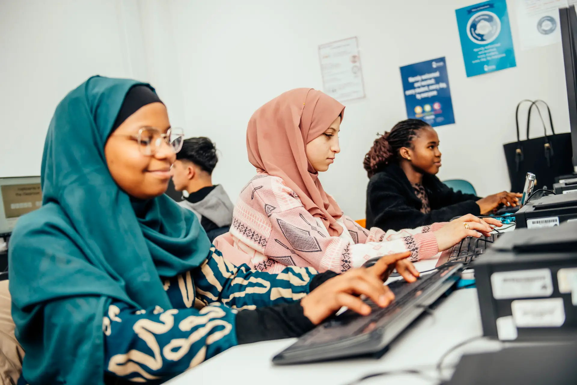 Adult learners working on computers