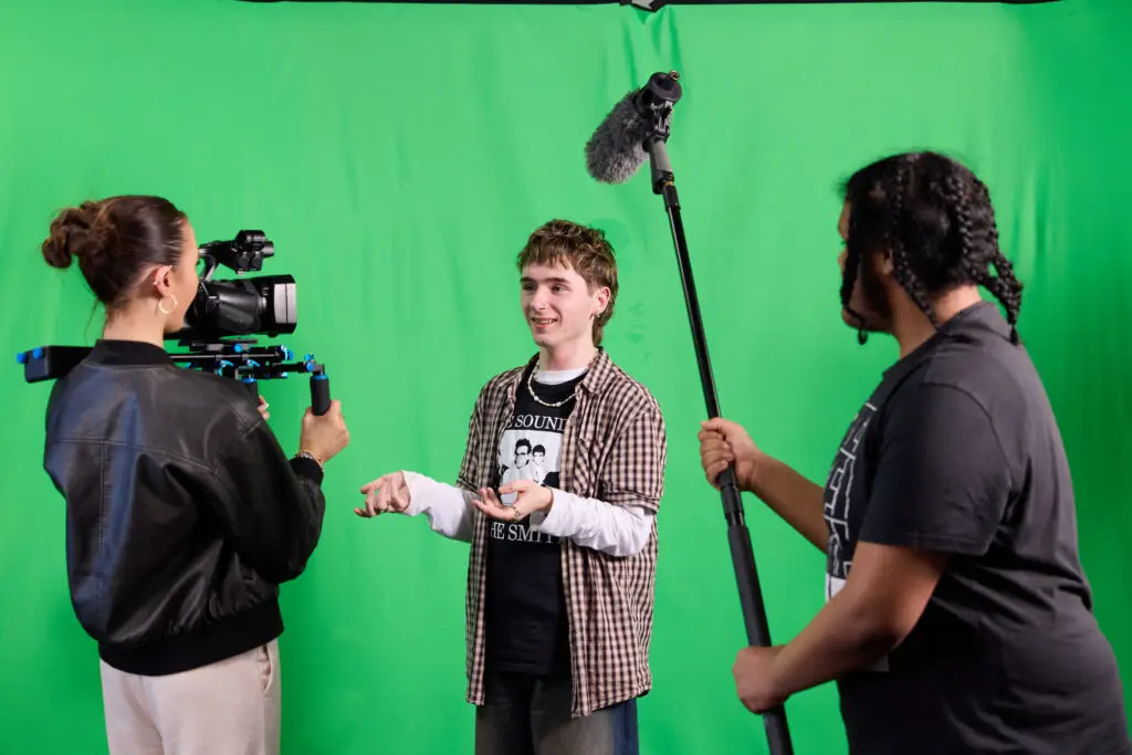 Media students in front of a green screen