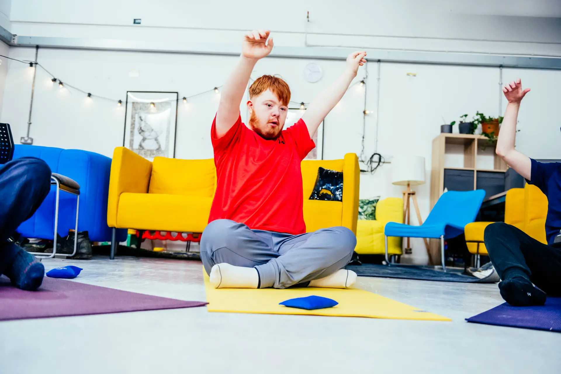 Student in red T shirt takes part in yoga session