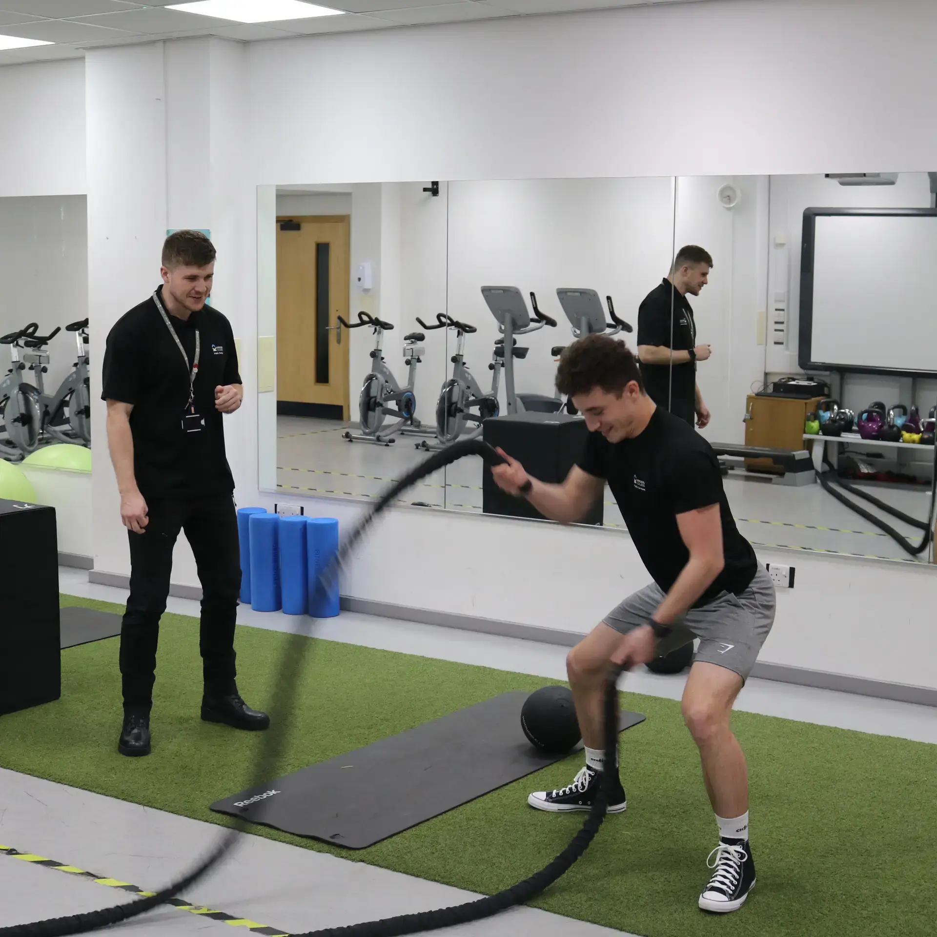 boy in black gym suit with trainer