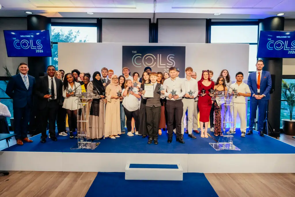 COLS winners stand in a crowd on stage
