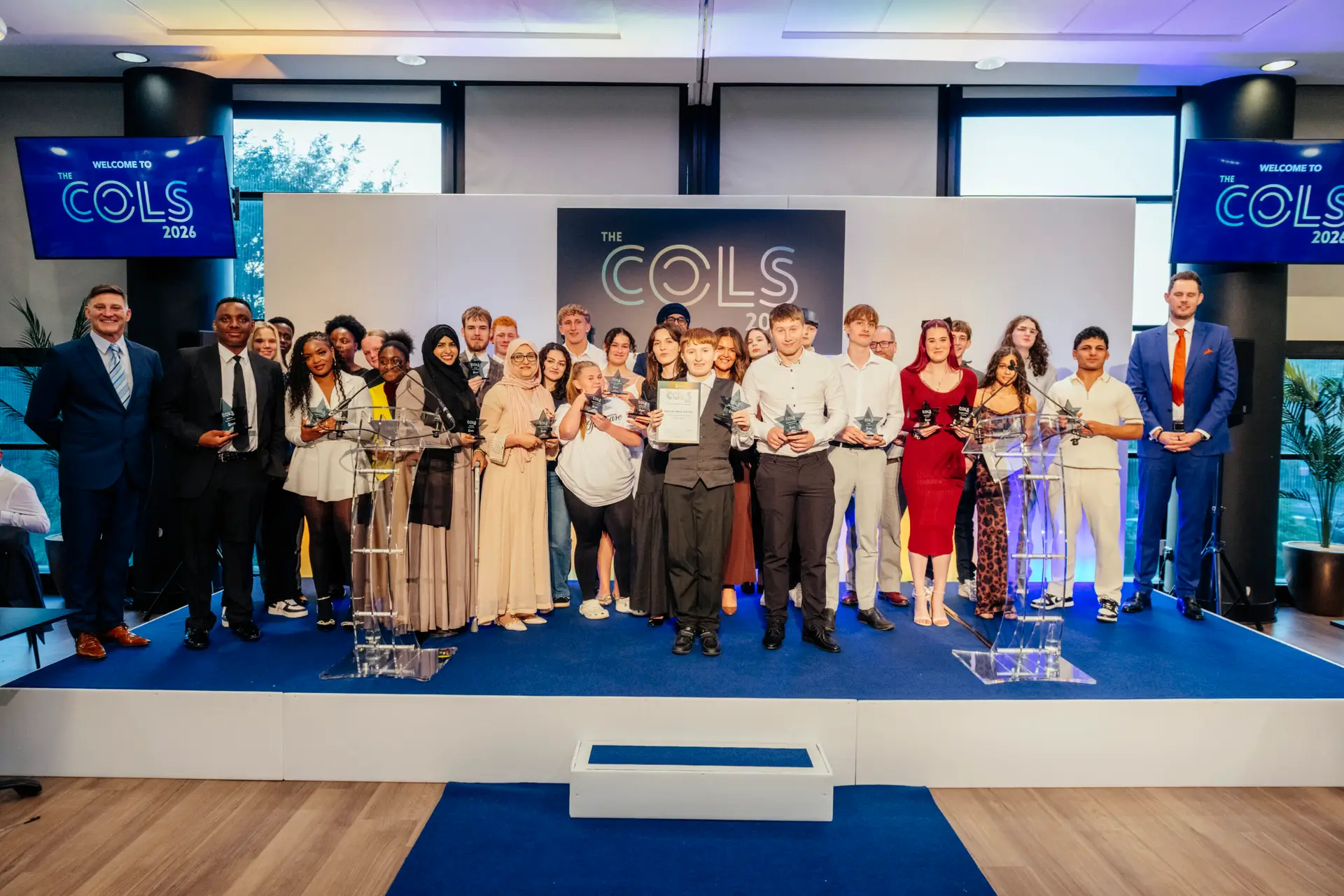 COLS winners stand in a crowd on stage