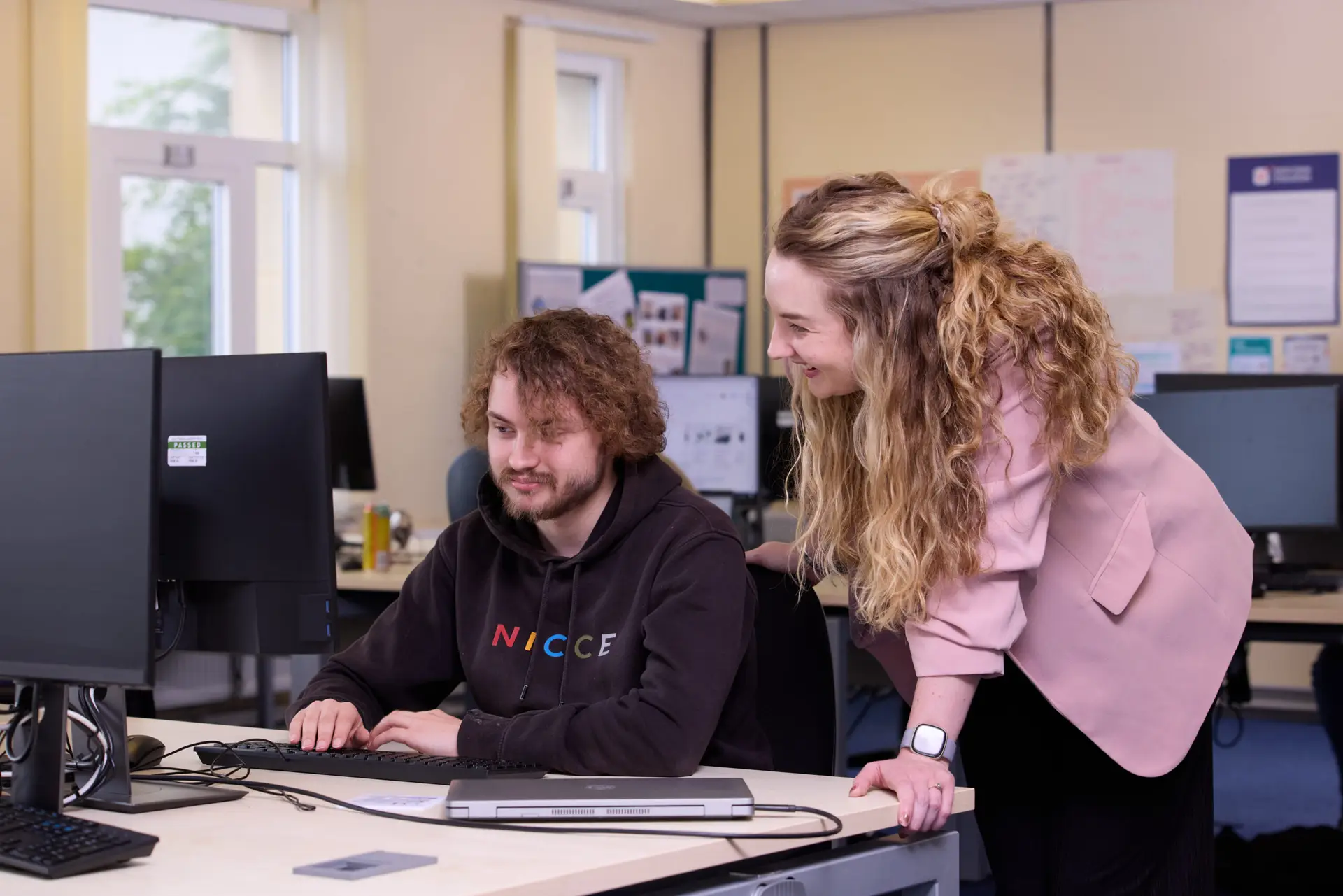 student with teacher in IT room
