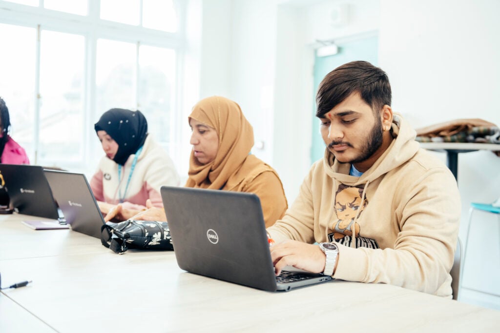 digital skills students working on laptops
