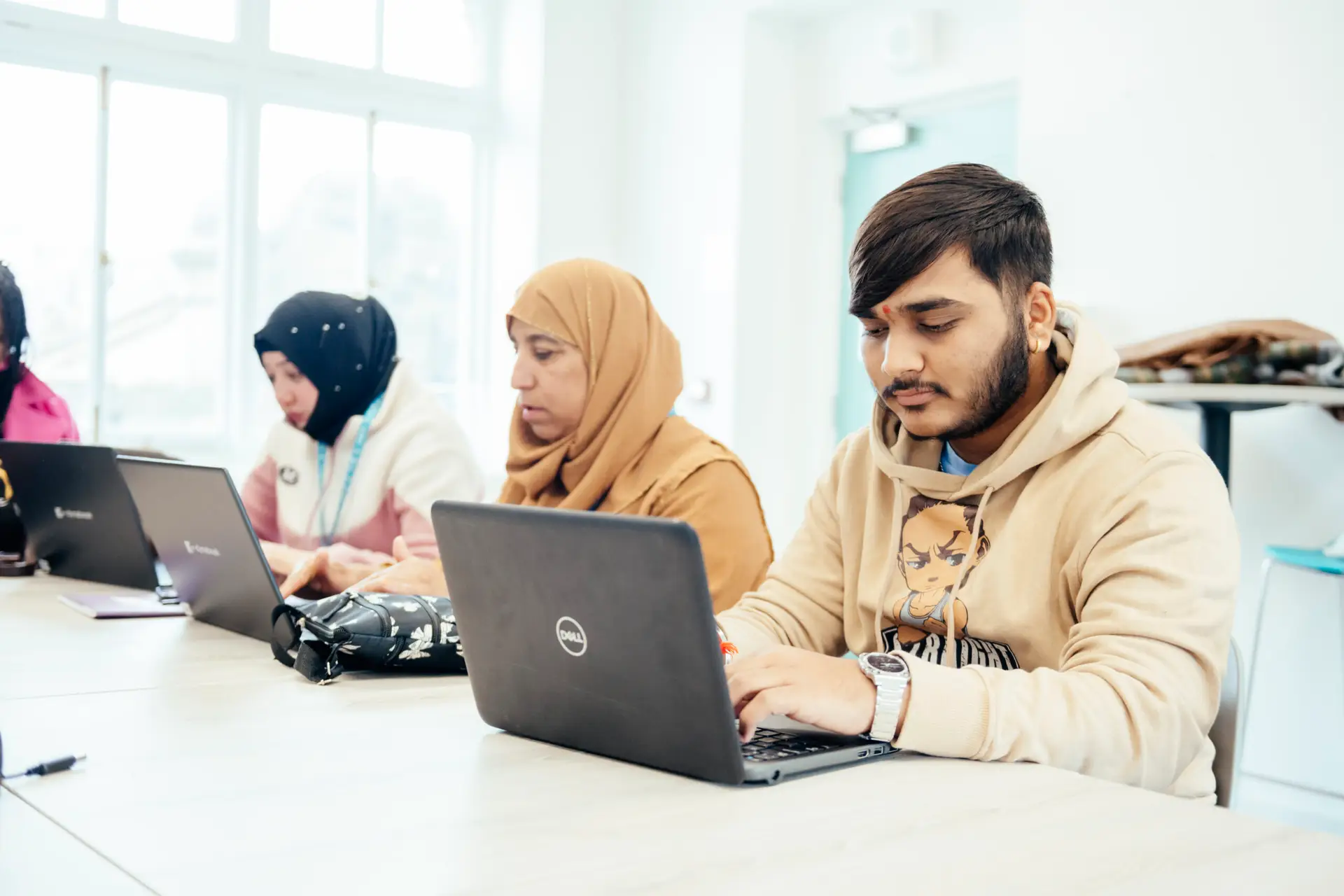 digital skills students working on laptops