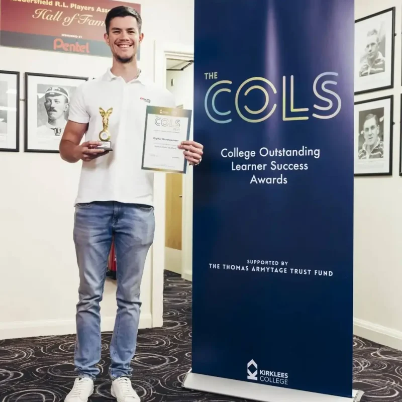 A man in a white polo shirt holding a trophy and certificate stands next to a blue banner for the College Outstanding Learner Success Awards.